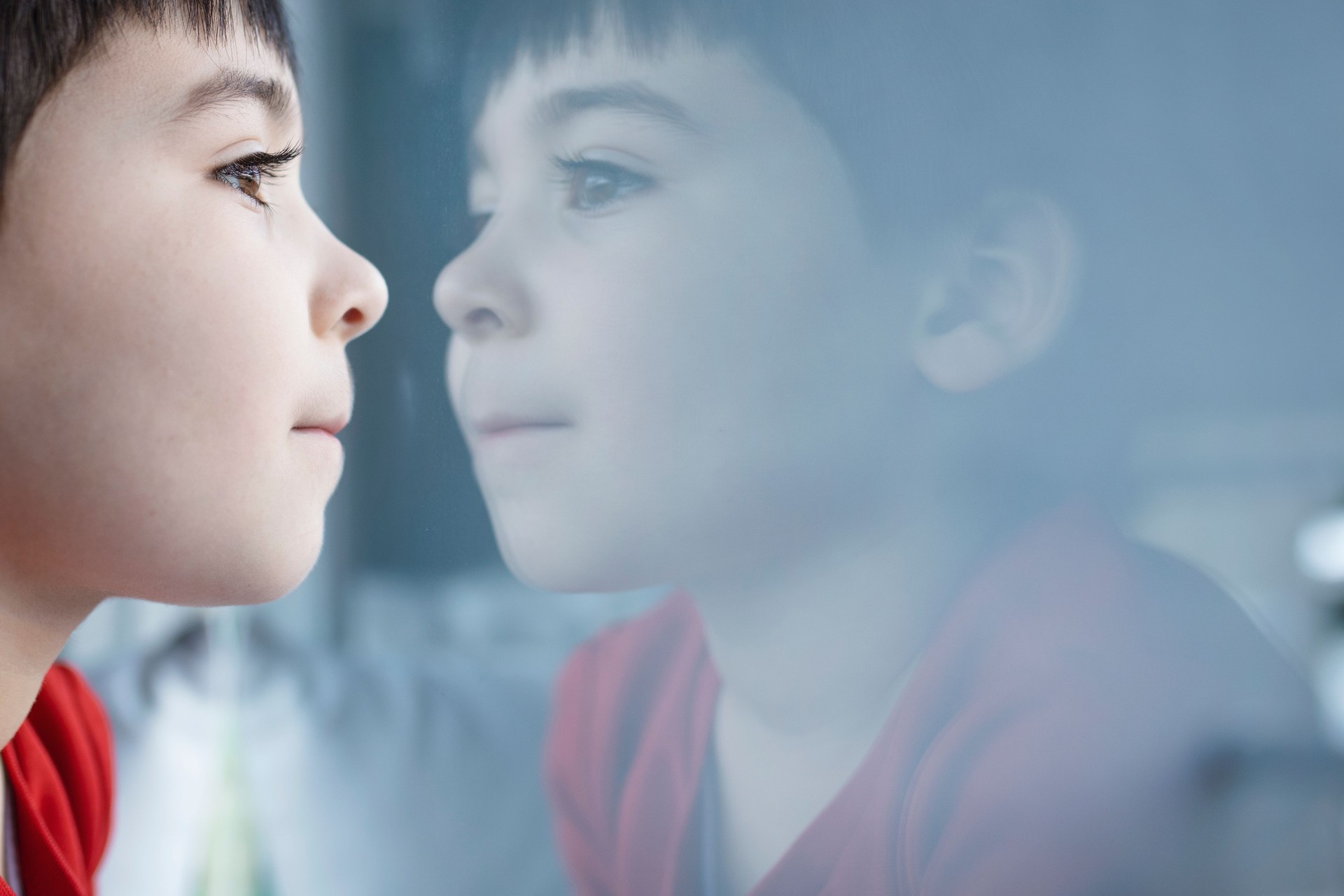 Little boy looking out of the window